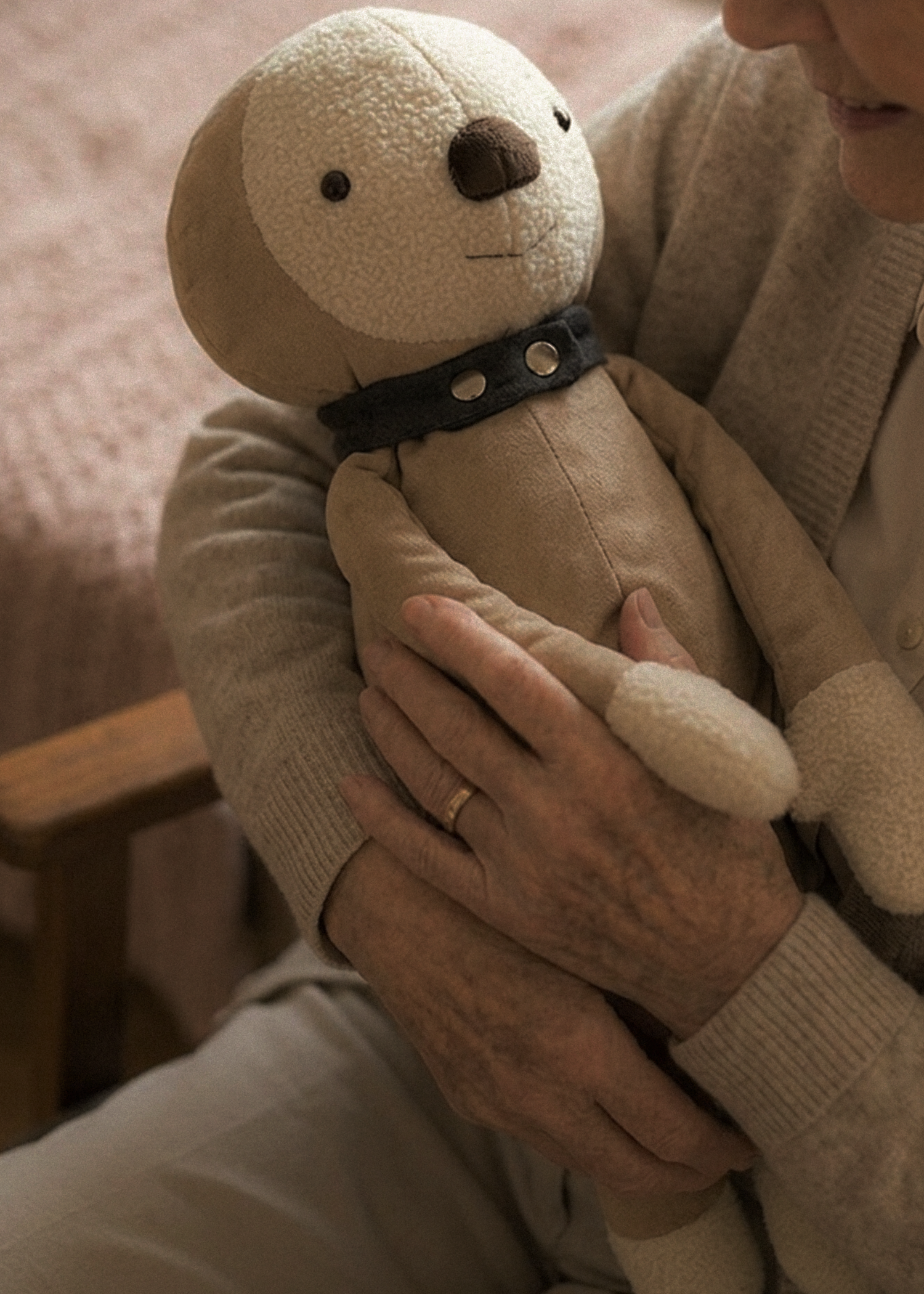 Sunny held by a caregiver